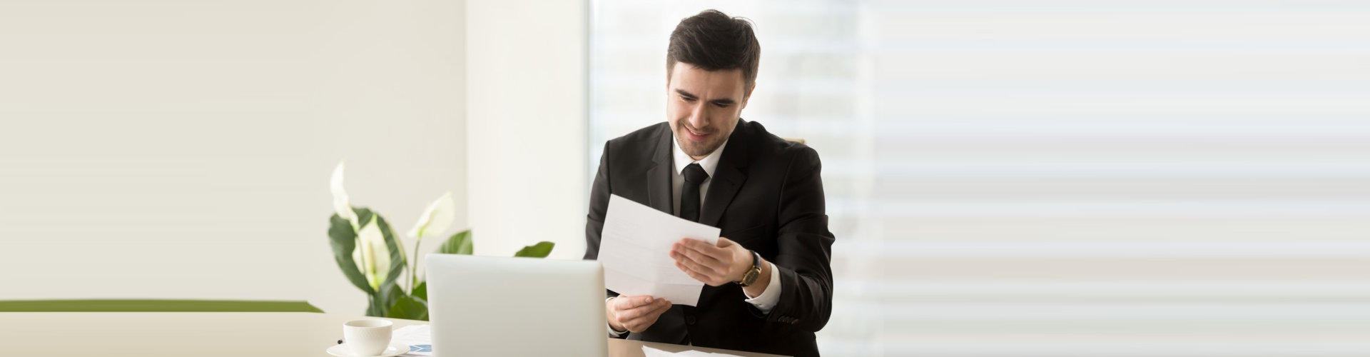 a professional man reading a paper